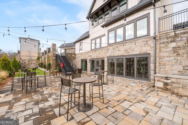 view of patio featuring stairs and outdoor dining area