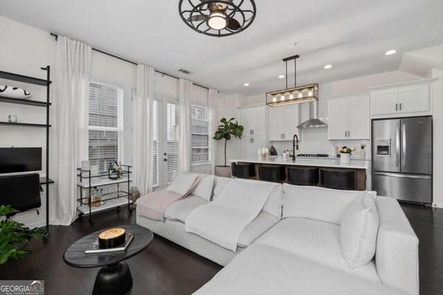 living room with visible vents, dark wood finished floors, french doors, and recessed lighting