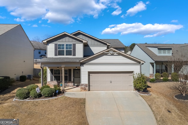 craftsman inspired home with concrete driveway, stone siding, covered porch, central air condition unit, and board and batten siding