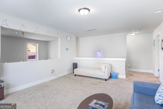 living area with carpet, visible vents, and baseboards