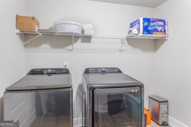 clothes washing area featuring laundry area and washer and clothes dryer