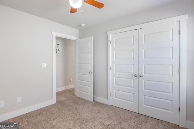 unfurnished bedroom featuring a closet, carpet, a ceiling fan, and baseboards