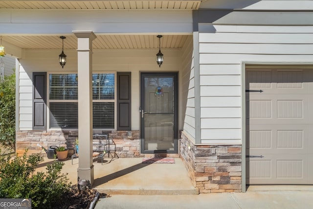 property entrance featuring stone siding and covered porch