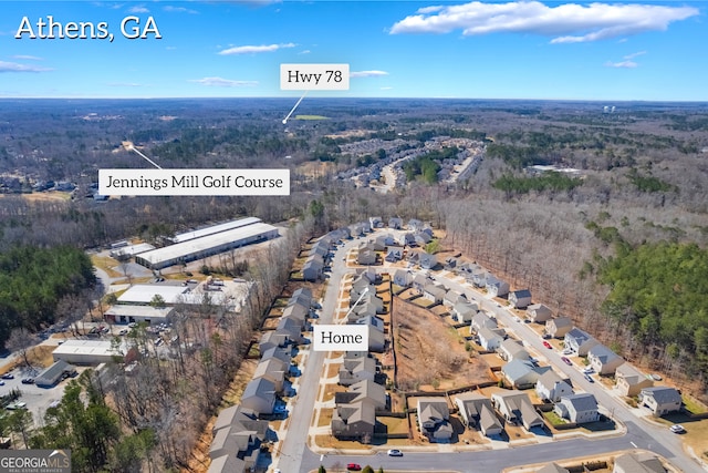 birds eye view of property featuring a residential view and a forest view