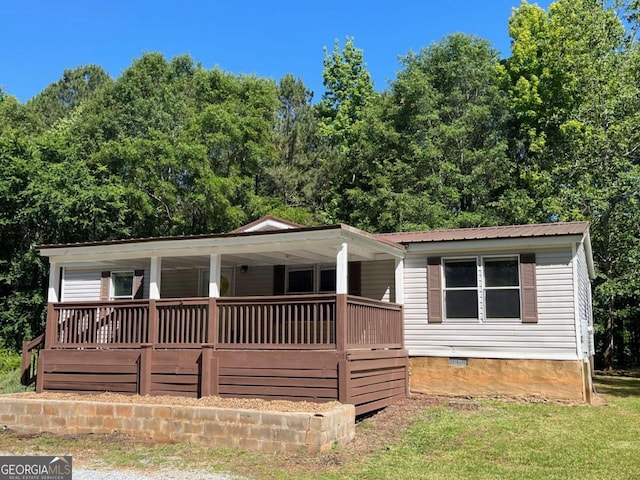 view of front of house featuring crawl space, covered porch, and metal roof