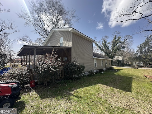 view of side of property with a yard