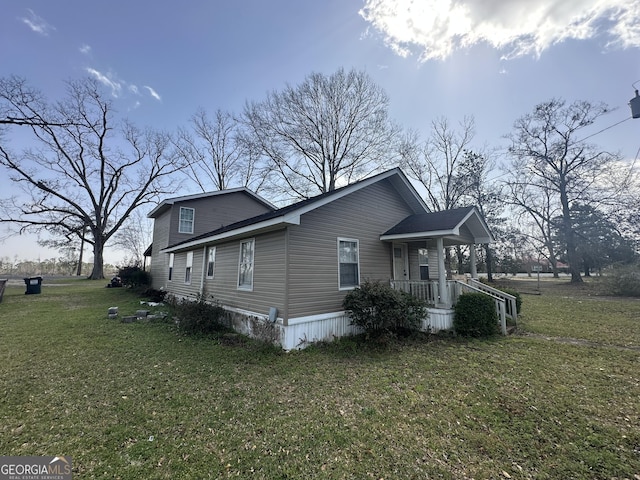 view of side of home featuring a yard