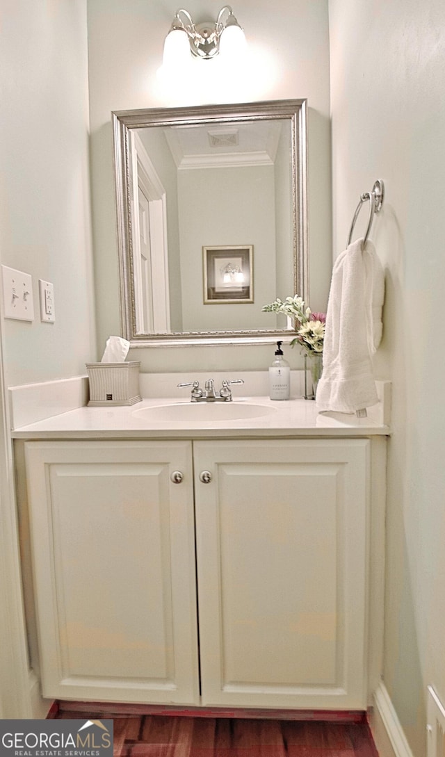 bathroom with crown molding and vanity