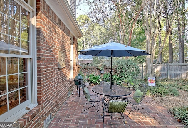 view of patio / terrace featuring outdoor dining area and fence