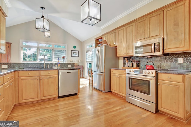 kitchen featuring stainless steel appliances, tasteful backsplash, light brown cabinets, and light wood-style flooring