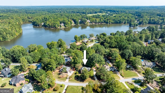 birds eye view of property featuring a water view and a forest view