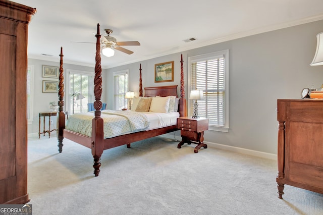 carpeted bedroom with ornamental molding, multiple windows, visible vents, and baseboards