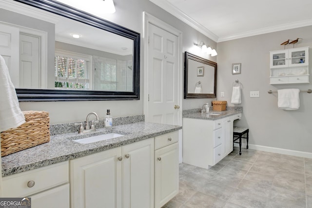 bathroom featuring two vanities, a sink, baseboards, an enclosed shower, and crown molding