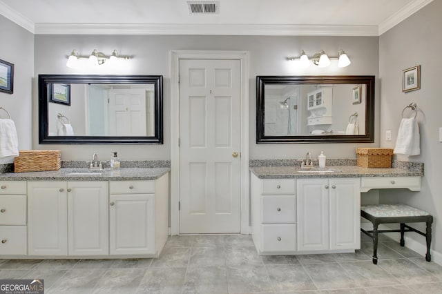 bathroom featuring ornamental molding, two vanities, a sink, and visible vents