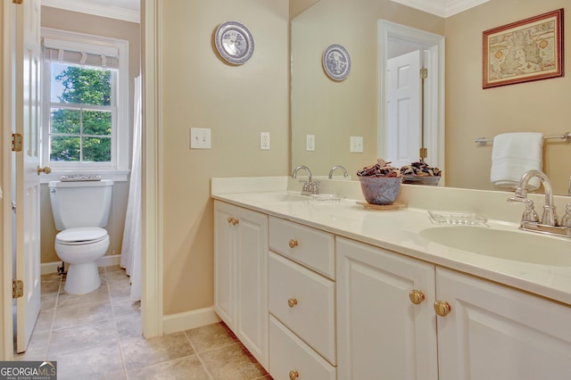 bathroom featuring double vanity, crown molding, baseboards, and a sink