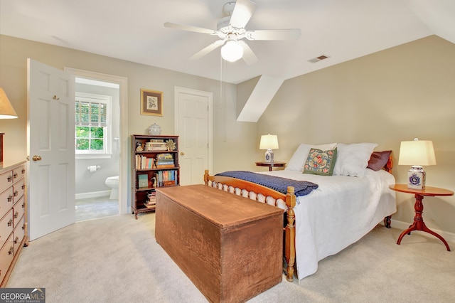 bedroom featuring light carpet, baseboards, visible vents, a ceiling fan, and connected bathroom