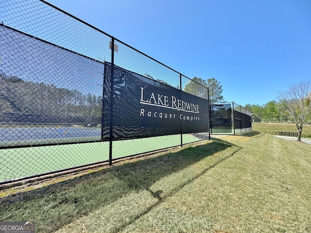 view of tennis court with fence