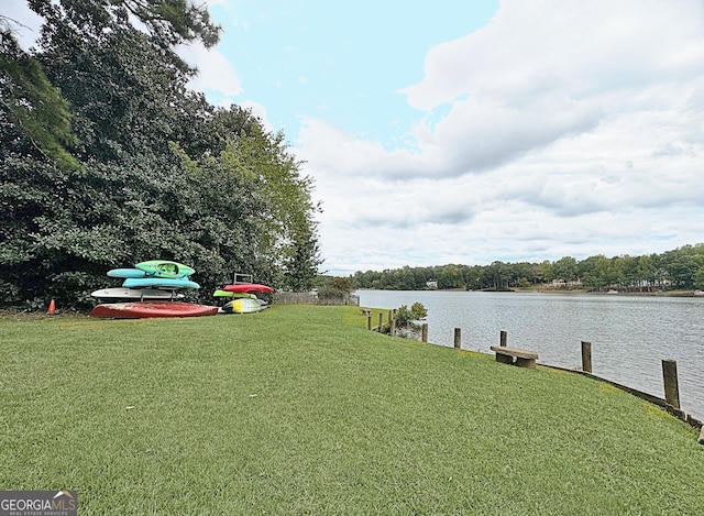 view of yard featuring a dock and a water view