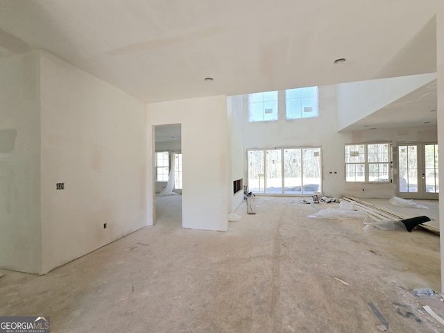 unfurnished living room featuring french doors