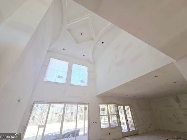 interior space featuring french doors and a towering ceiling