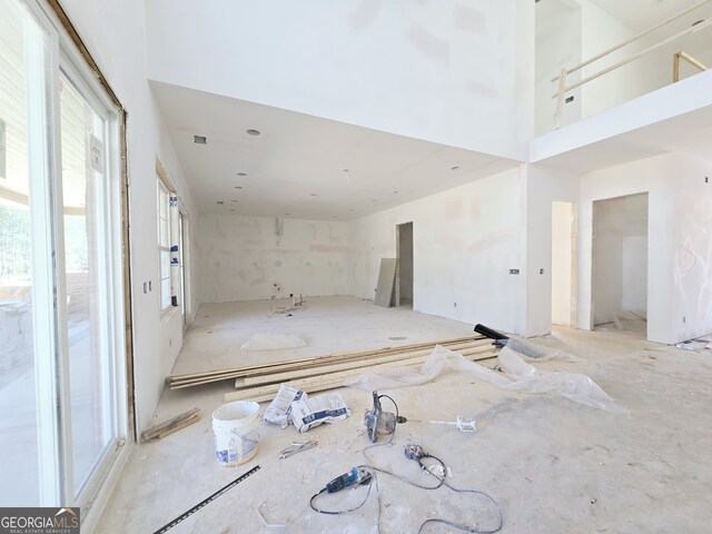 unfurnished room with a towering ceiling