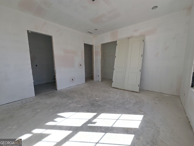 unfurnished bedroom featuring visible vents