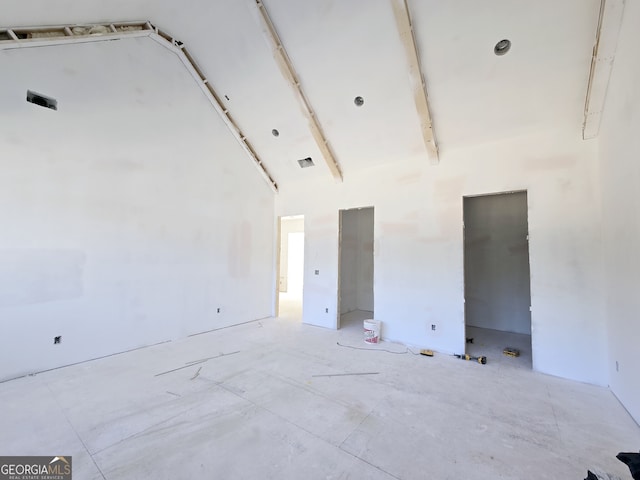 spare room featuring a towering ceiling and visible vents