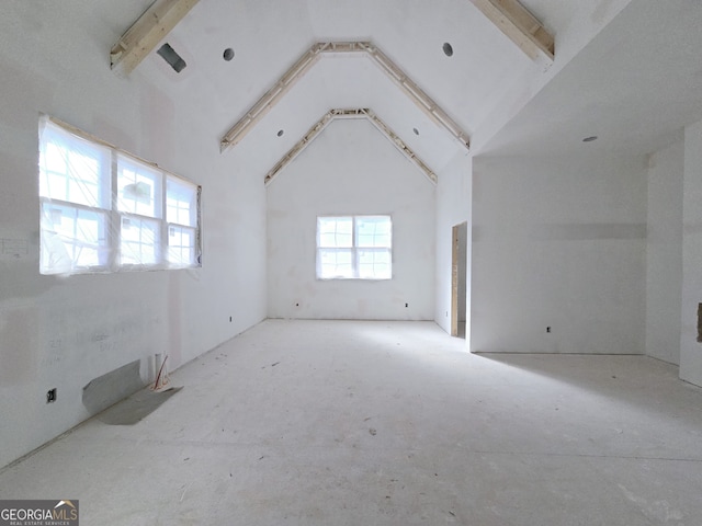 empty room featuring high vaulted ceiling