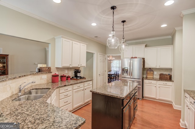1433 Henderson Ridge Ln, Loganville, GA 30052 - kitchen with stainless steel fridge, white cabinetry, light wood-style flooring, and a sink