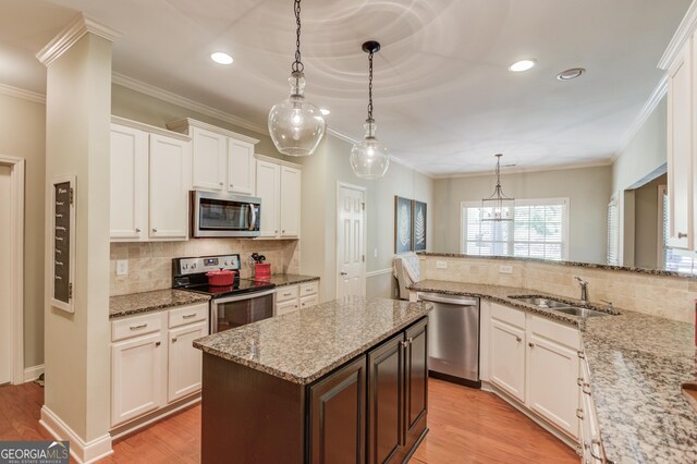 1433 Henderson Ridge Ln, Loganville, GA 30052 - kitchen featuring light wood finished floors, white cabinetry, appliances with stainless steel finishes, and a sink