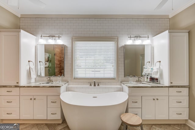 1433 Henderson Ridge Ln, Loganville, GA 30052 - full bathroom featuring a freestanding tub, crown molding, a ceiling fan, and a sink