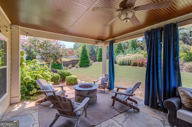 1433 Henderson Ridge Ln, Loganville, GA 30052 - view of patio / terrace with an outdoor fire pit, fence, and a ceiling fan