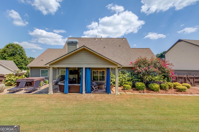 1433 Henderson Ridge Ln, Loganville, GA 30052 - back of house with fence, a yard, roof with shingles, a patio area, and a hot tub