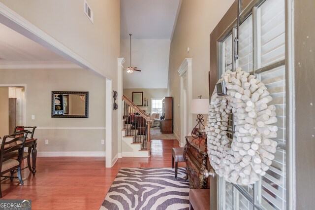 1433 Henderson Ridge Ln, Loganville, GA 30052 - foyer entrance with wood finished floors, a ceiling fan, visible vents, stairs, and baseboards