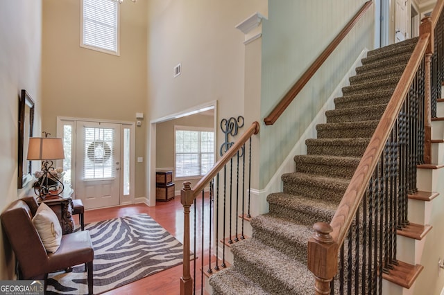1433 Henderson Ridge Ln, Loganville, GA 30052 - entrance foyer with baseboards, visible vents, a high ceiling, and wood finished floors