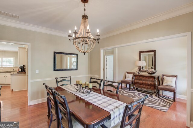 1433 Henderson Ridge Ln, Loganville, GA 30052 - dining room featuring crown molding, light wood finished floors, visible vents, and baseboards