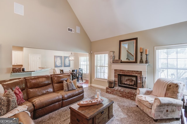 1433 Henderson Ridge Ln, Loganville, GA 30052 - carpeted living room with high vaulted ceiling, baseboards, a fireplace, and visible vents