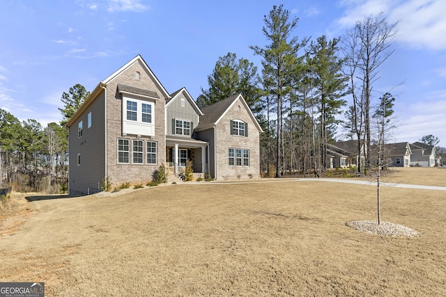 traditional-style house featuring brick siding and board and batten siding