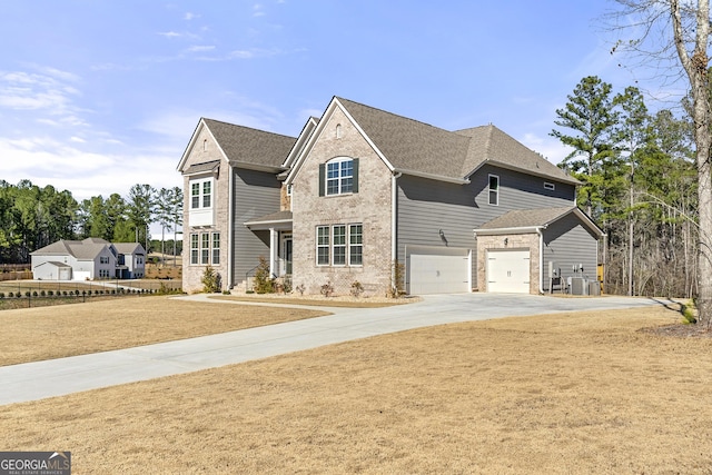 traditional-style home with brick siding, central AC unit, driveway, and a garage