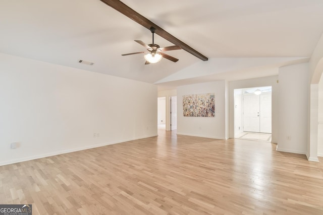 unfurnished living room featuring baseboards, lofted ceiling with beams, light wood-style flooring, arched walkways, and a ceiling fan