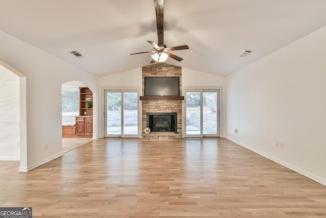 unfurnished living room featuring a wealth of natural light, visible vents, and light wood-type flooring