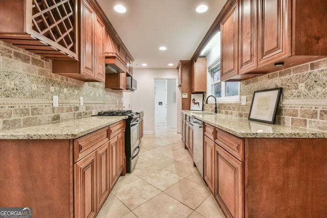 kitchen with brown cabinets, a sink, light stone counters, stainless steel appliances, and light tile patterned floors