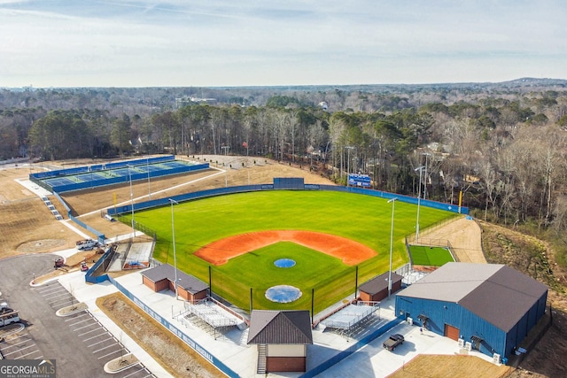 birds eye view of property featuring a view of trees