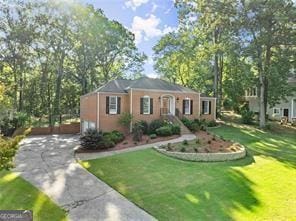 view of front of property with a garage, driveway, and a front lawn