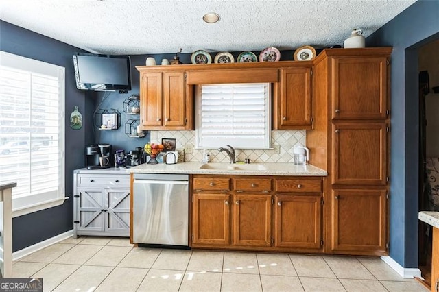 kitchen with a sink, light countertops, and dishwasher