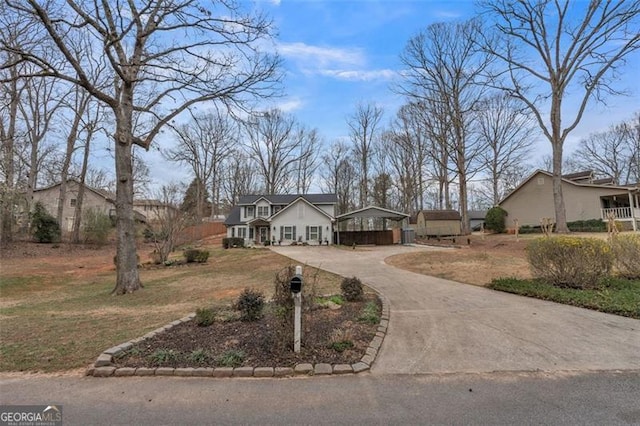 view of front of property with driveway and a front yard