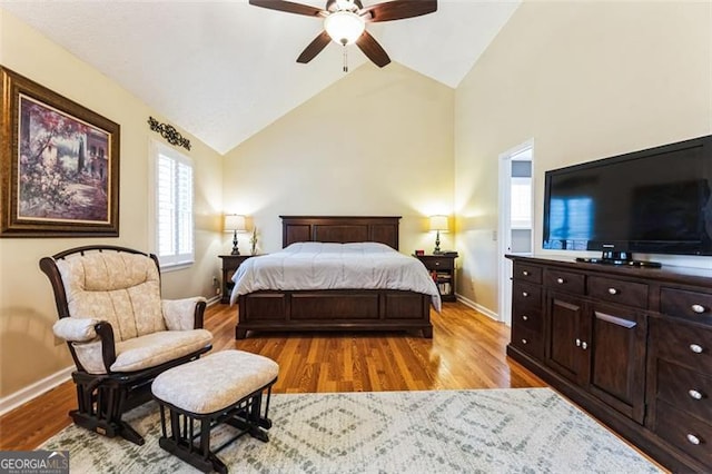 bedroom featuring light wood-type flooring, baseboards, a ceiling fan, and lofted ceiling