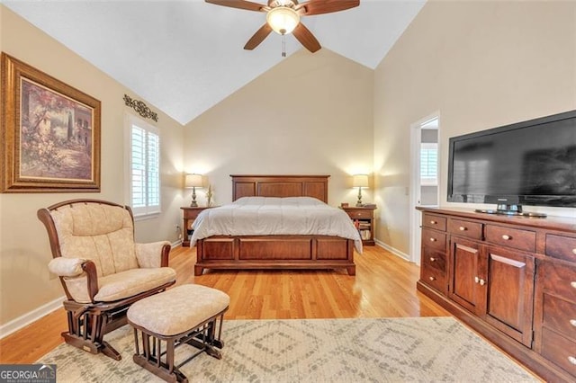 bedroom featuring high vaulted ceiling, light wood-style flooring, baseboards, and a ceiling fan