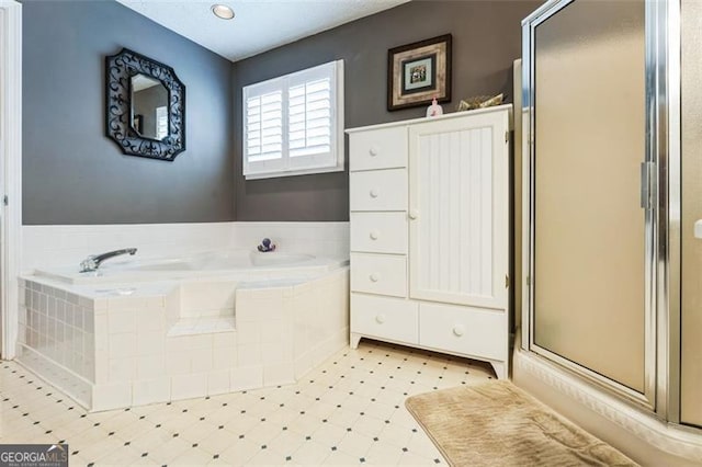 full bath with a garden tub, a shower stall, and tile patterned floors