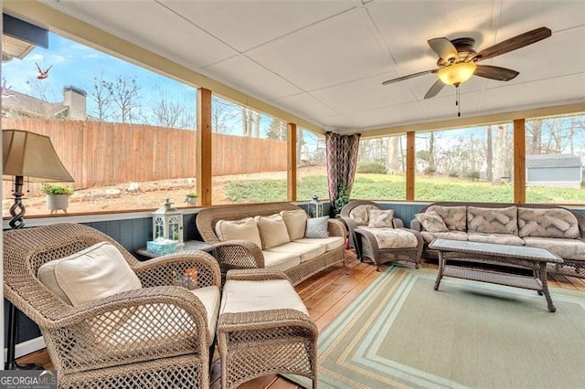 sunroom featuring a wealth of natural light and ceiling fan